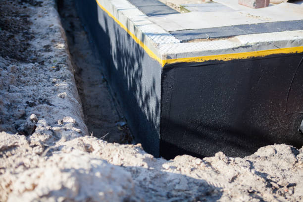 Professional Waterproofing technician working in Iola, KS